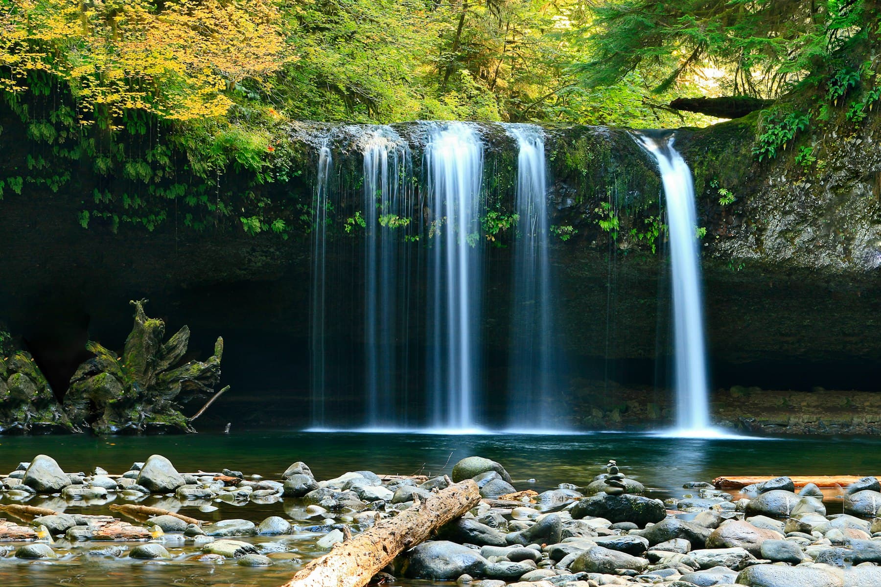 Granite boulders and clear water in a tropical gorge rainforest.